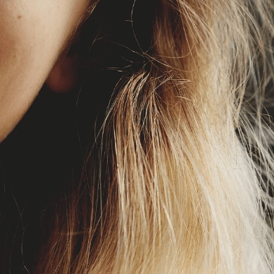 image of a very happy woman smiling with very healthy and hydrated skin.